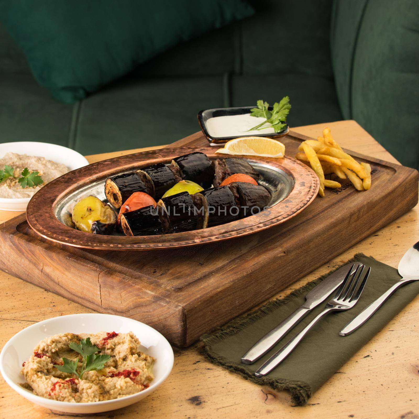 Dining table full of delicious dishes on a wooden desk by A_Karim