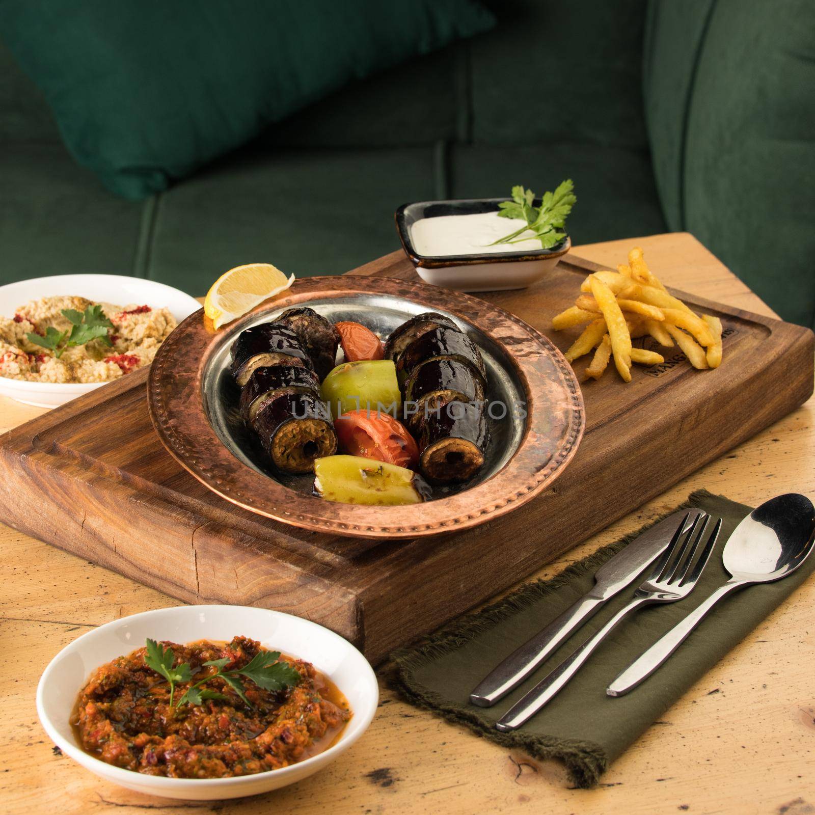 Dining table full of delicious dishes on a wooden desk by A_Karim