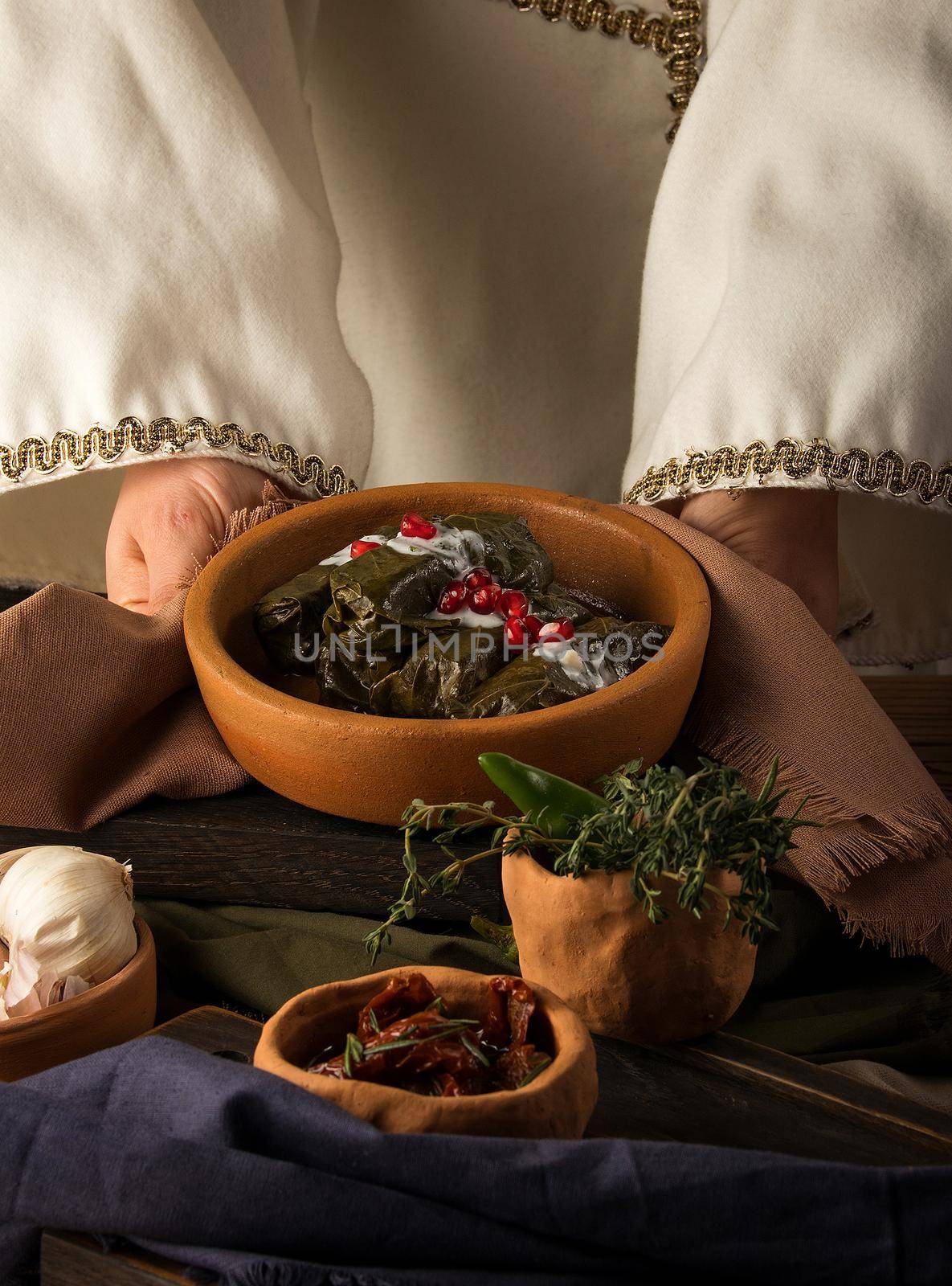 A close up shot of a dolma covered in grape leaves