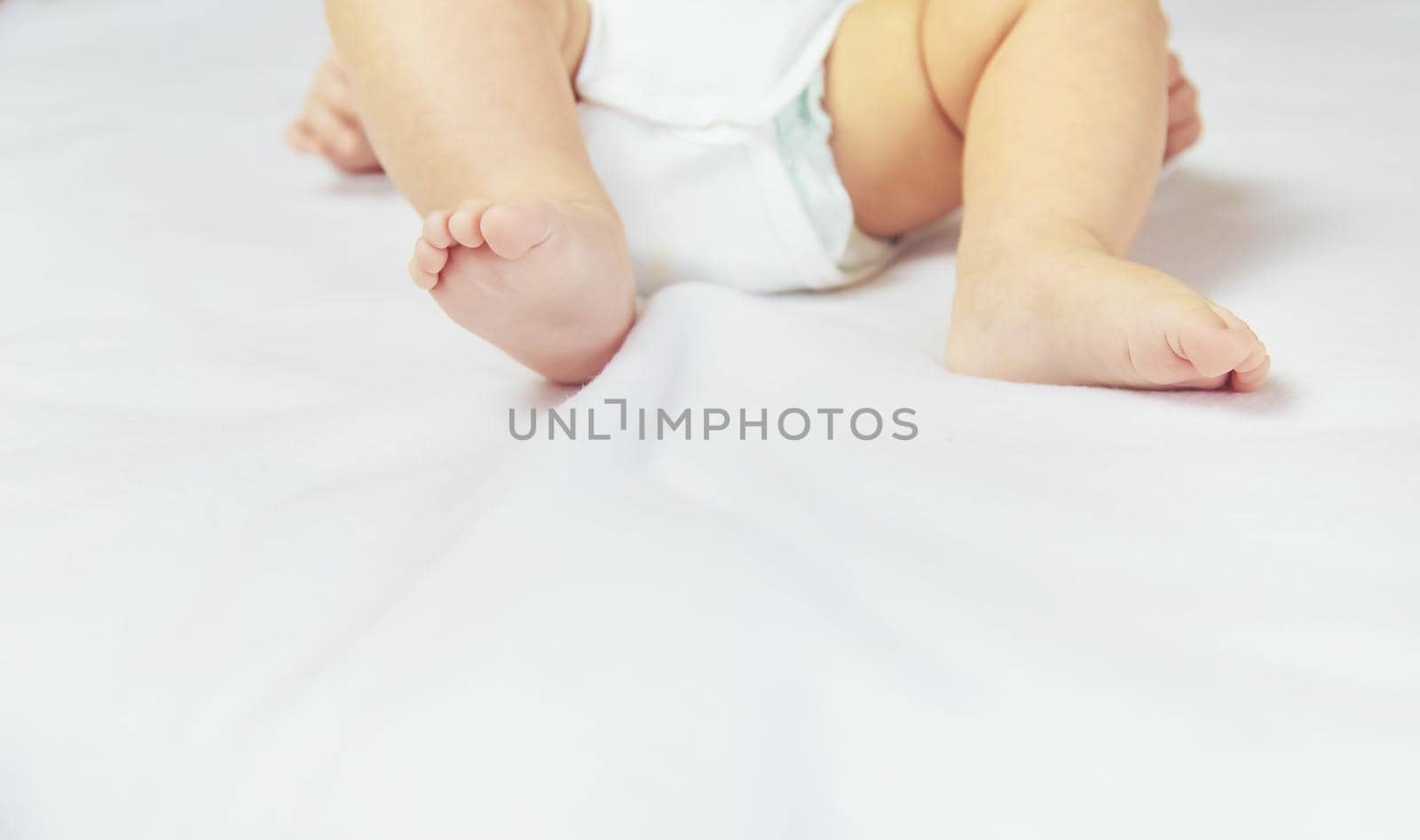Legs of a little baby on a white background. Selective focus. people.