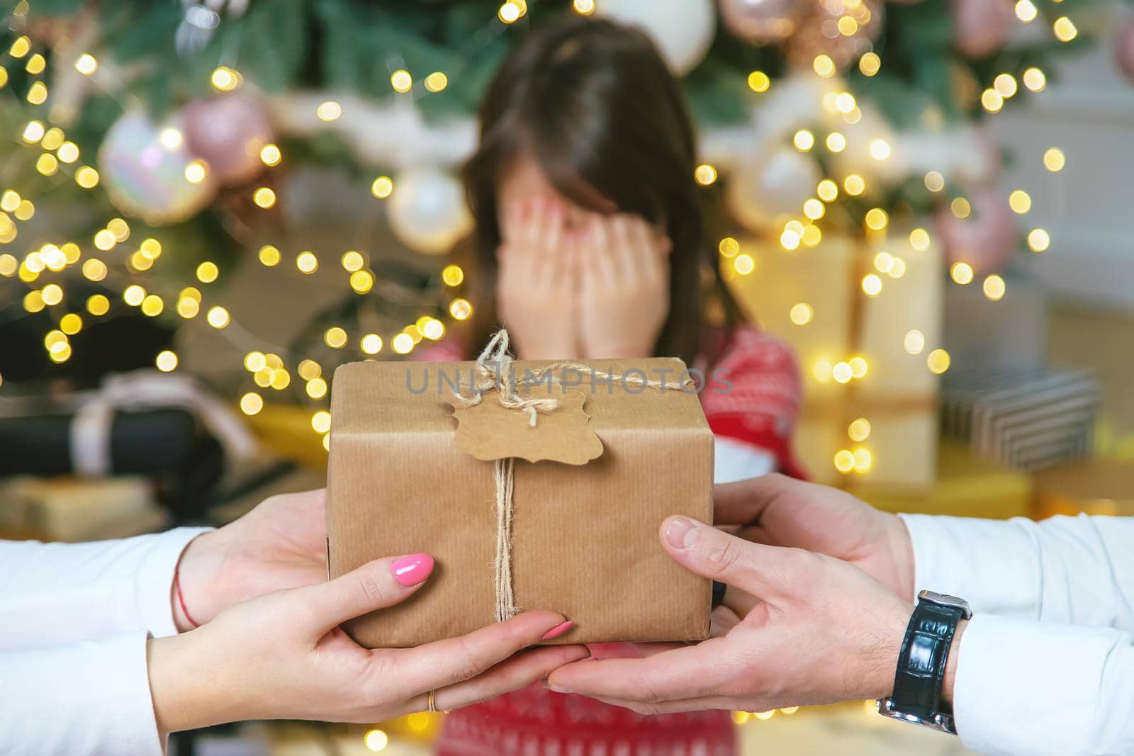 Child girl parents give presents for christmas. Selective focus. Holiday.