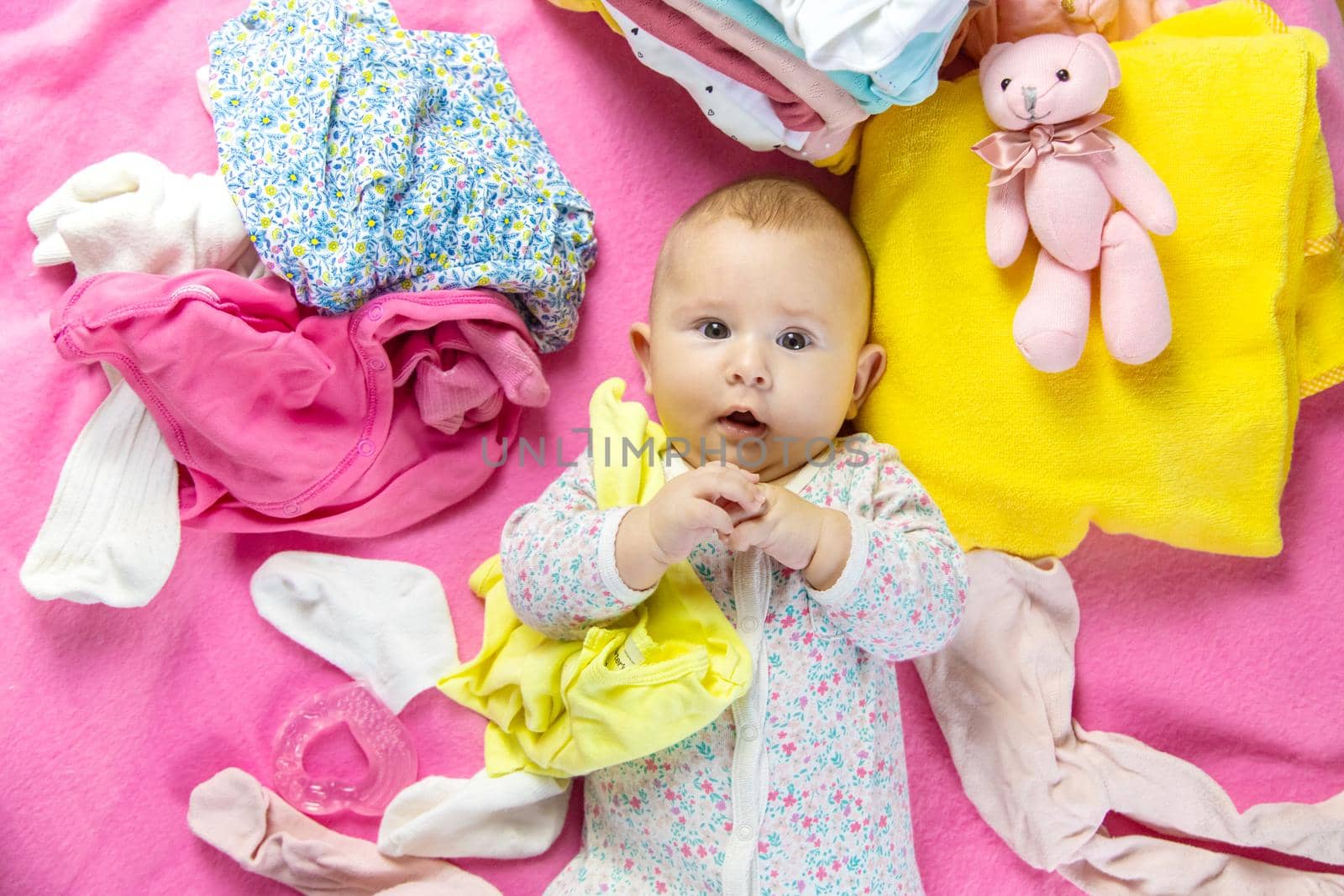 Baby scattered clothes and toys. Selective focus. people.