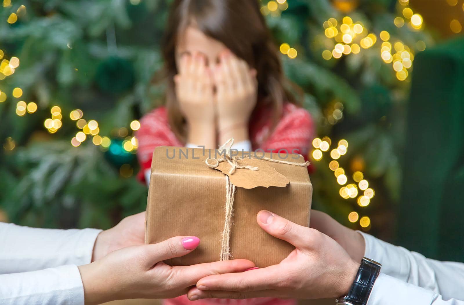 Child girl parents give presents for christmas. Selective focus. Holiday.
