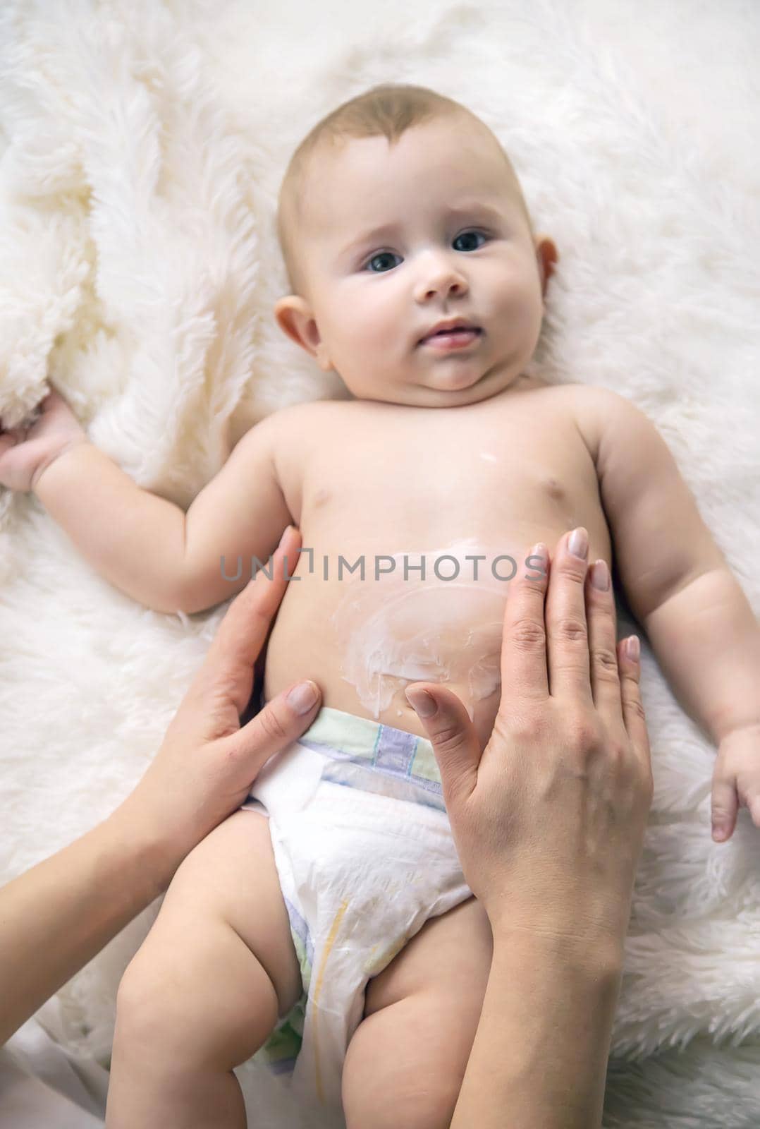 mother puts cream on little baby. Selective focus. by yanadjana