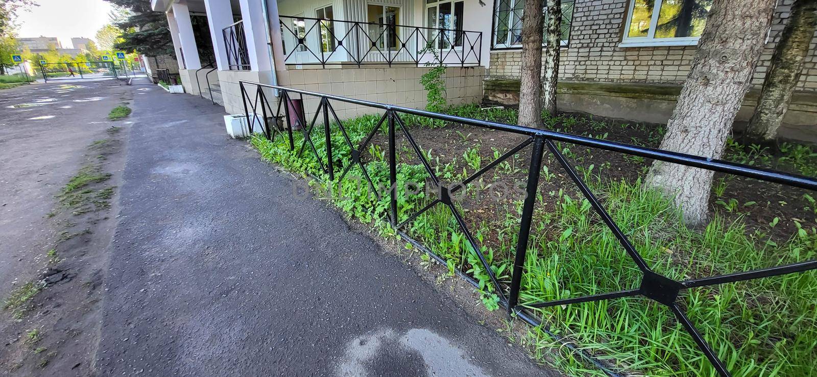 Black wrought iron fence in green grass.