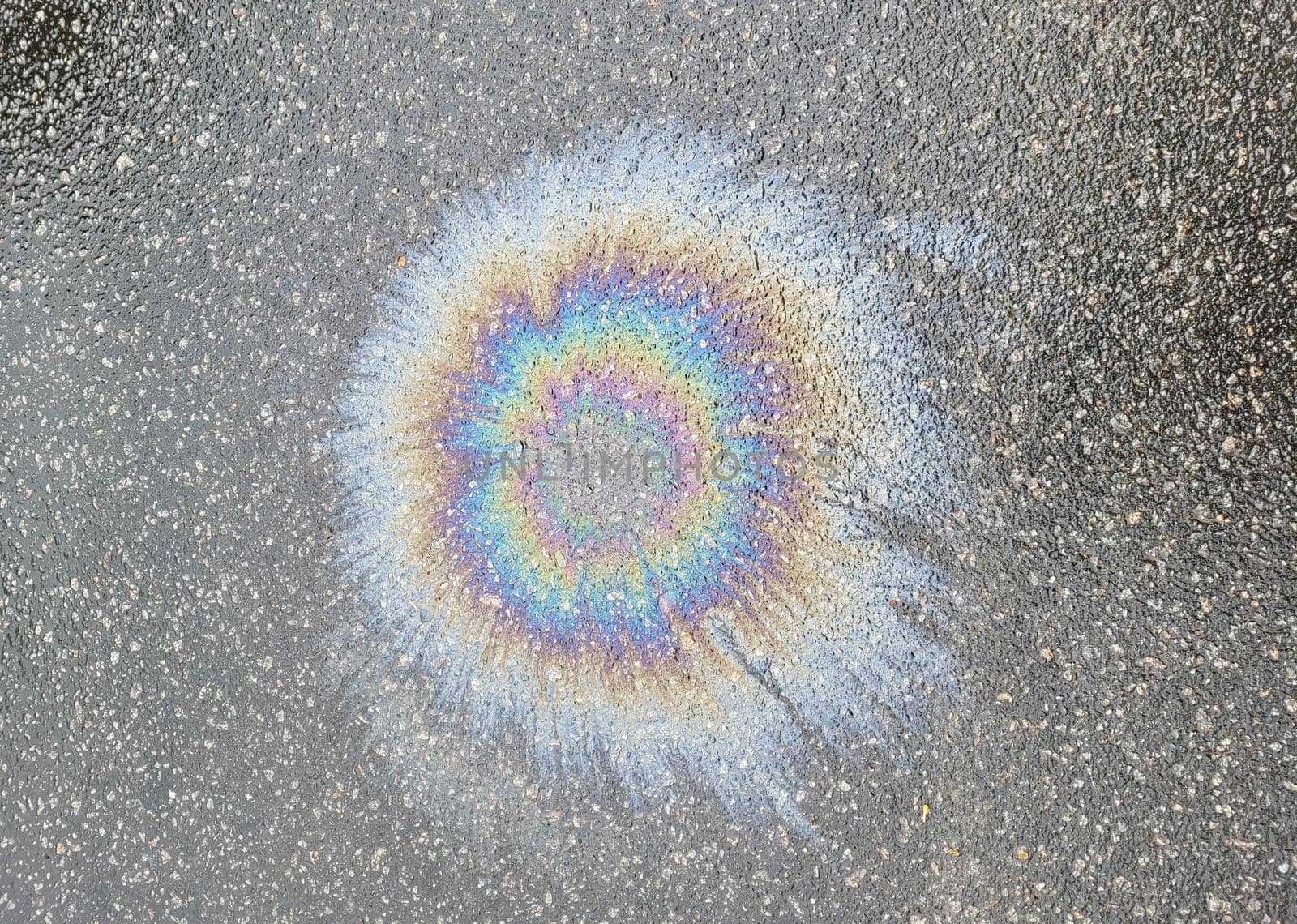 The color diluted with gasoline in a puddle. environmental pollution