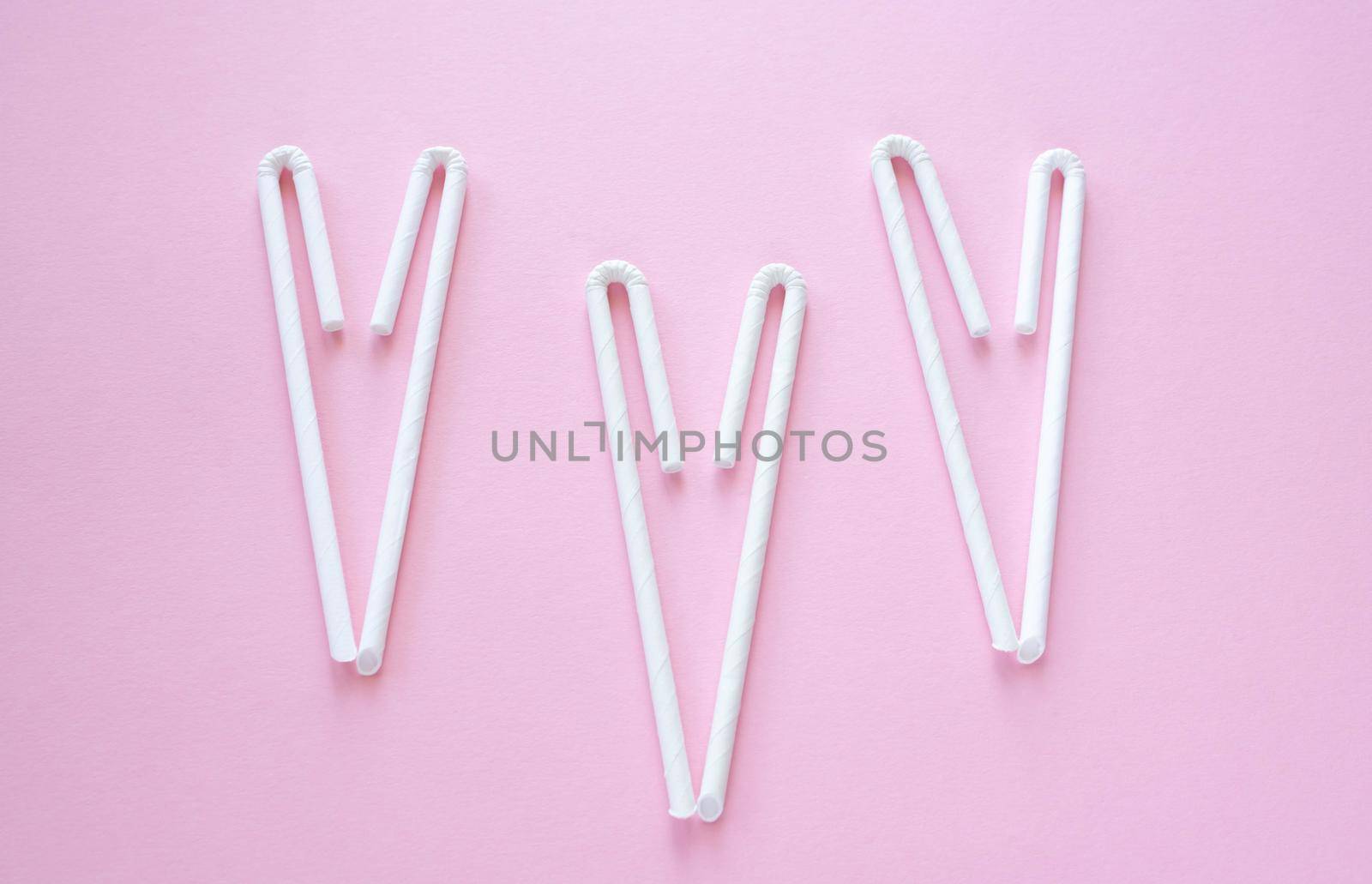 Cocktail Straws Day. Paper drinking straws on a pink background. Summer cocktail party, a fun and cheerful holiday concept by lapushka62