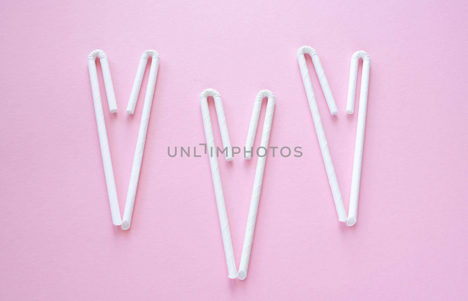 Cocktail Straws Day. Paper drinking straws on a pink background. Summer cocktail party, a fun and cheerful holiday concept.