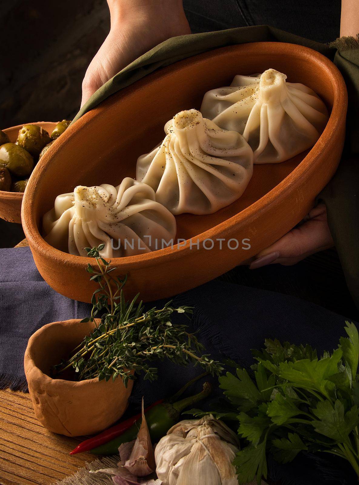 A vertical shot of a luxurious restaurant table with a gourmet khinkali dish