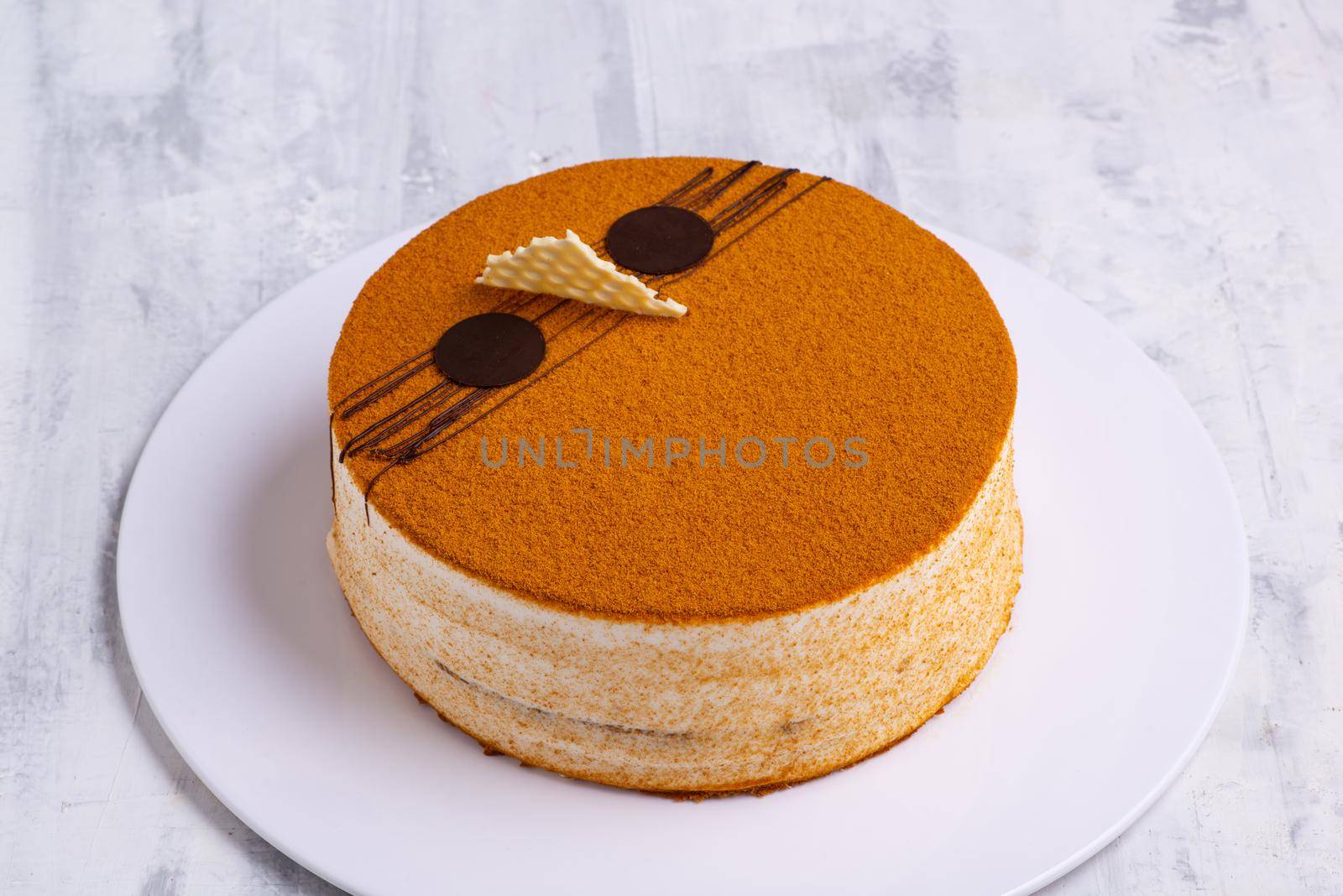 An angle shot of a traditional honey cake on a tray.