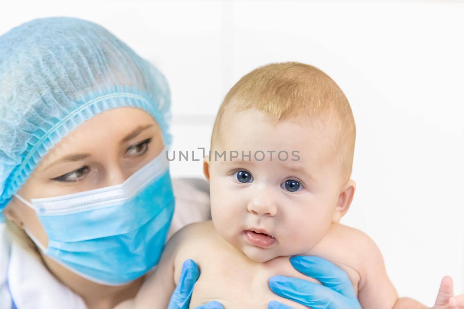 The baby is examined by a pediatrician at the hospital. Selective focus. people.