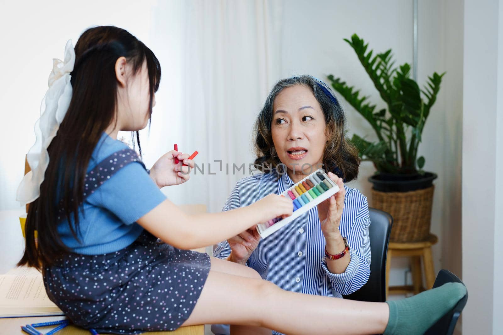 Asian portrait, grandchild granddaughter grandma grandmother and granddaughter happily join in activities to enhance skills for grandchildren.