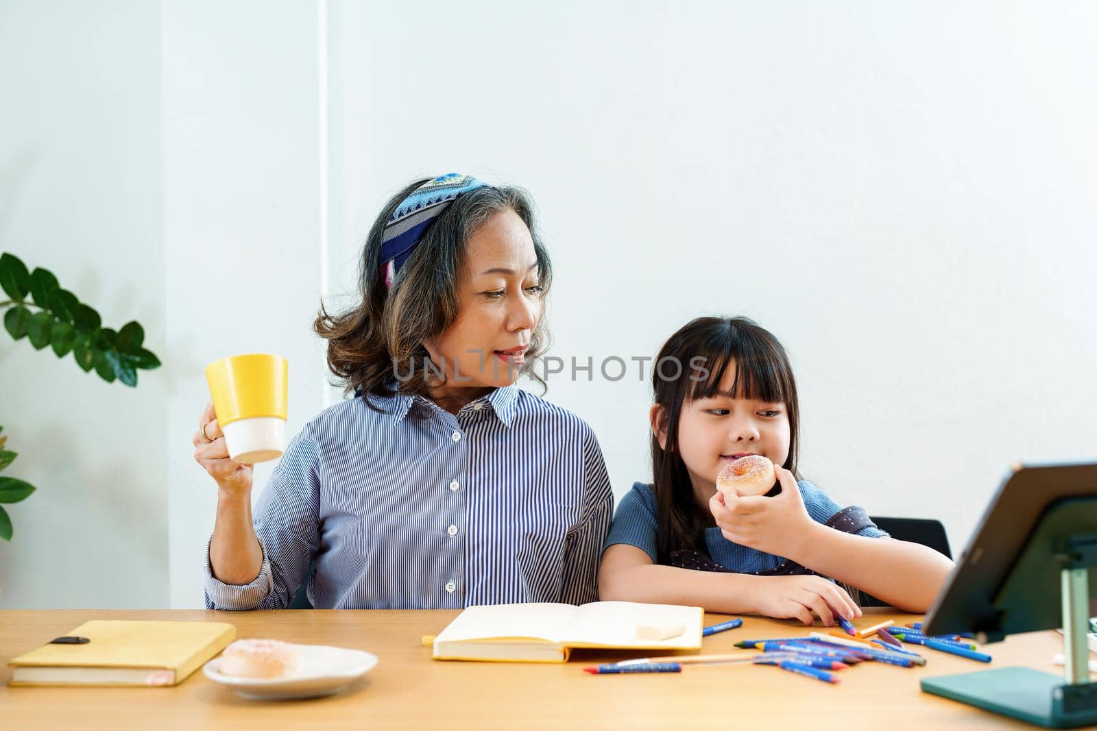 Asian portrait, grandchild granddaughter grandma grandmother and granddaughter happily join in activities to enjoy eating and enhance skills for grandchildren by Manastrong