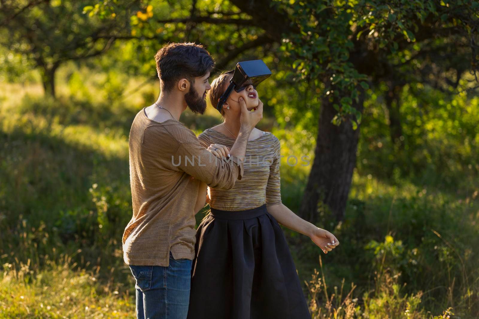 couple in nature, girl in virtual reality glasses close-up