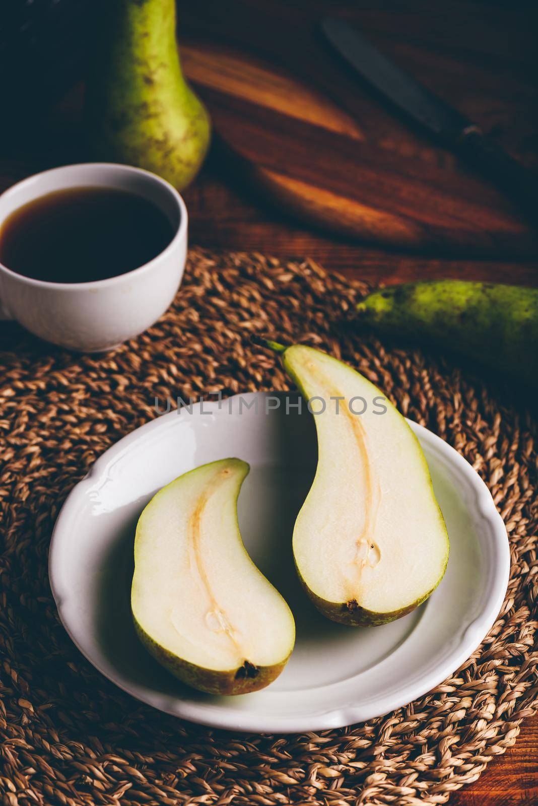 Halved Conference Pear on White Plate