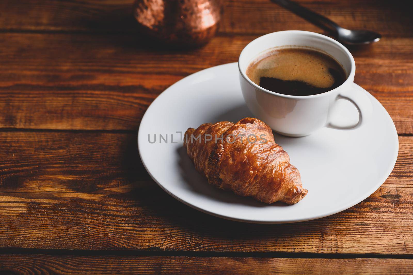 Cup of Black Coffee and Fresh Croissant by Seva_blsv