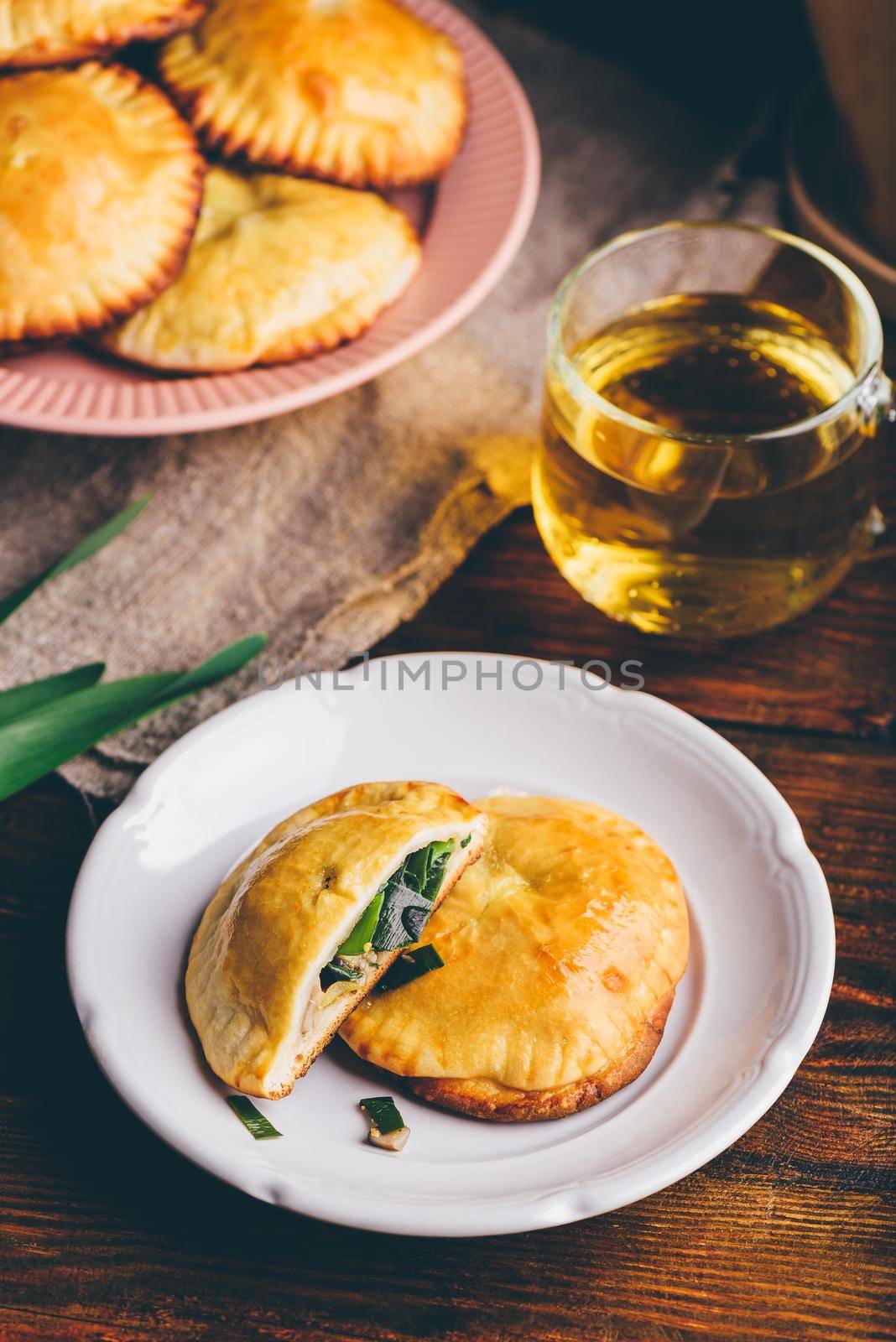 Oven Baked Pastries Stuffed with Siberian Chives and Mushrooms on White Plate