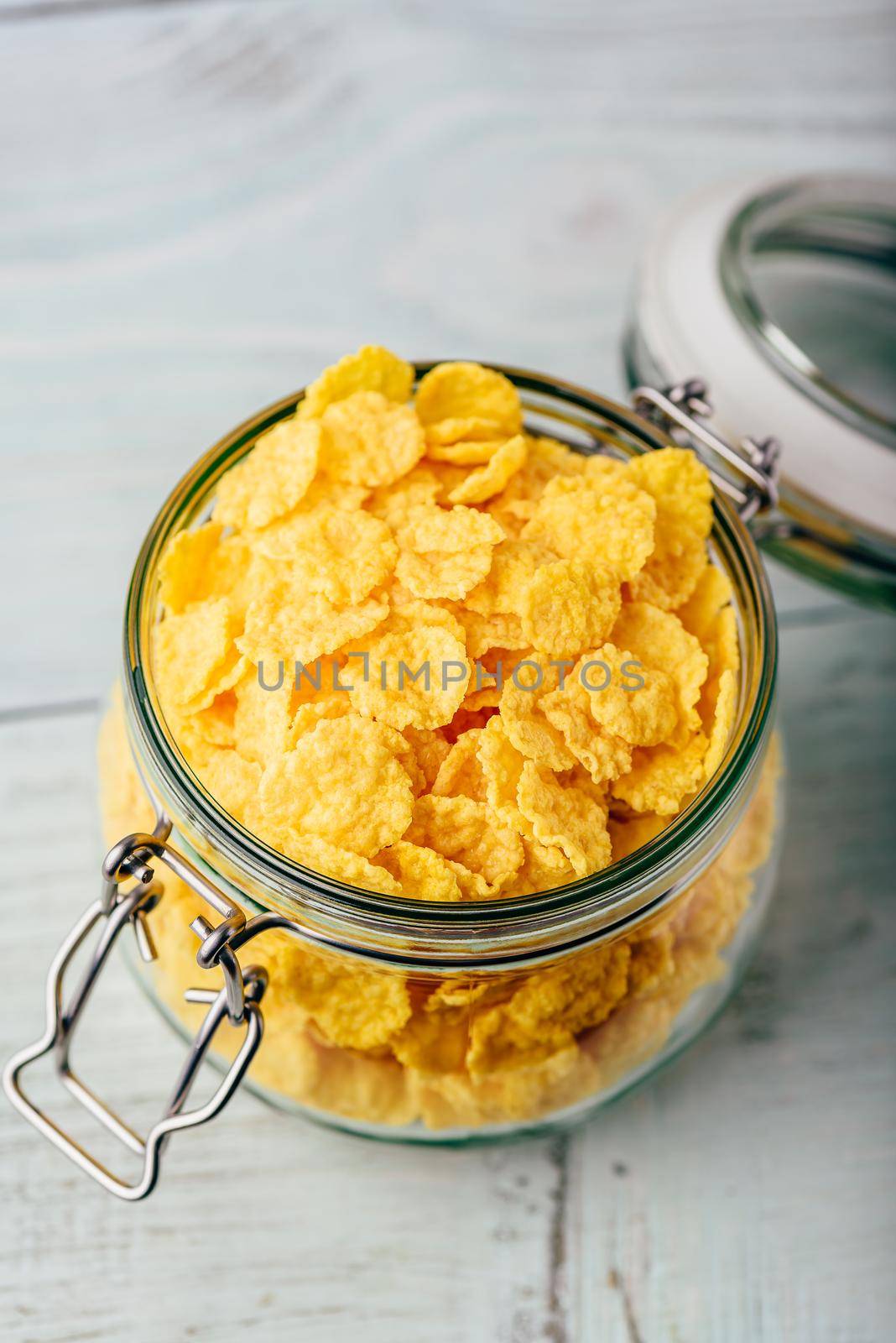 Corn flakes in a glass jar on wooden surface