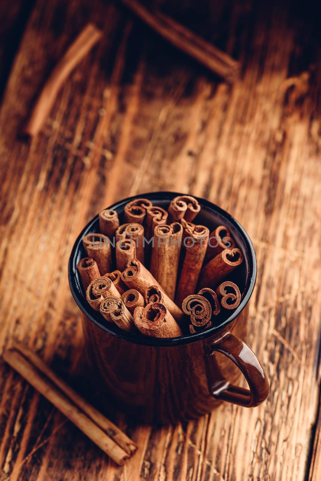 Cinnamon sticks in a metal mugr by Seva_blsv