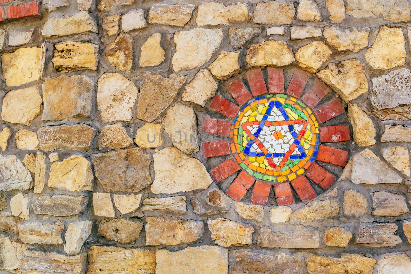 Mosaic star of David on stone wall. by Seva_blsv