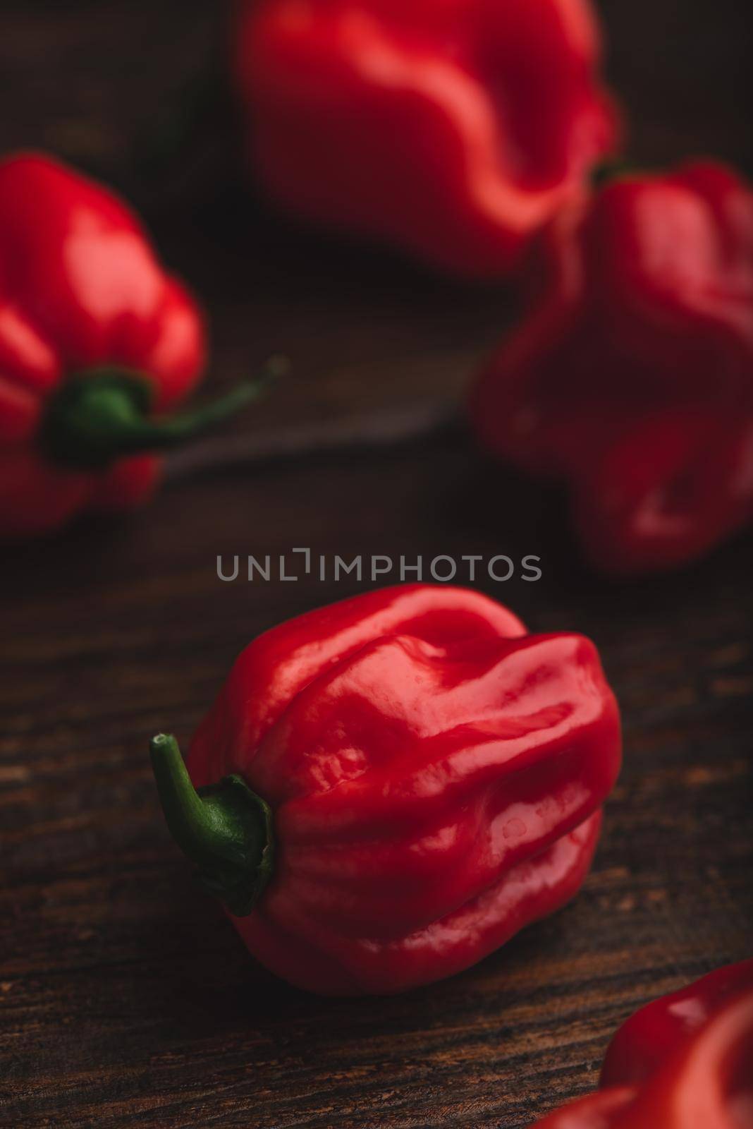 Red Habanero Pepper on a Wooden Table by Seva_blsv