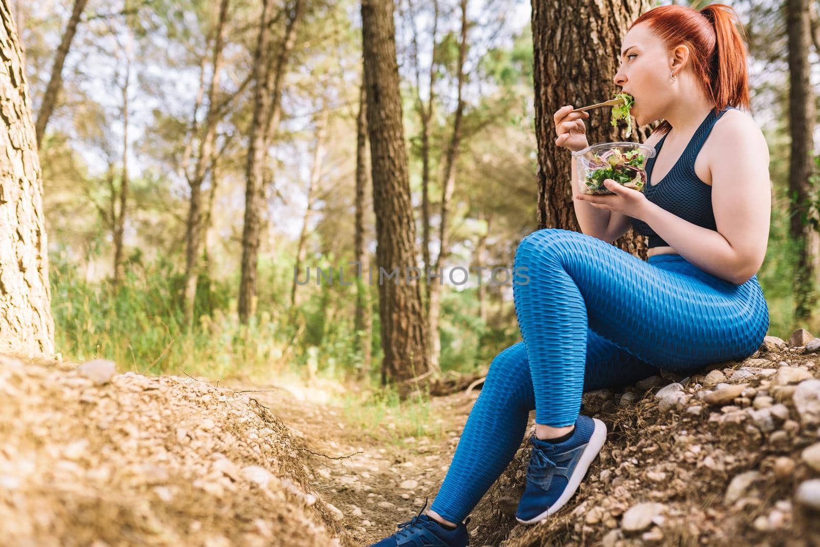 young girl athlete following a strict diet and training to achieve her goals. woman exercising outdoors. lifestyle health and wellness. by CatPhotography