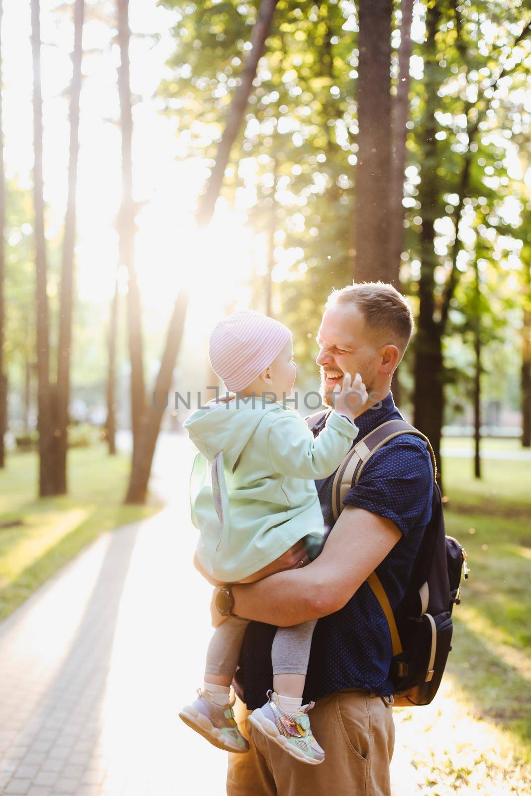 father's day concept. Dad and baby girl playing together outdoors in summer by paralisart