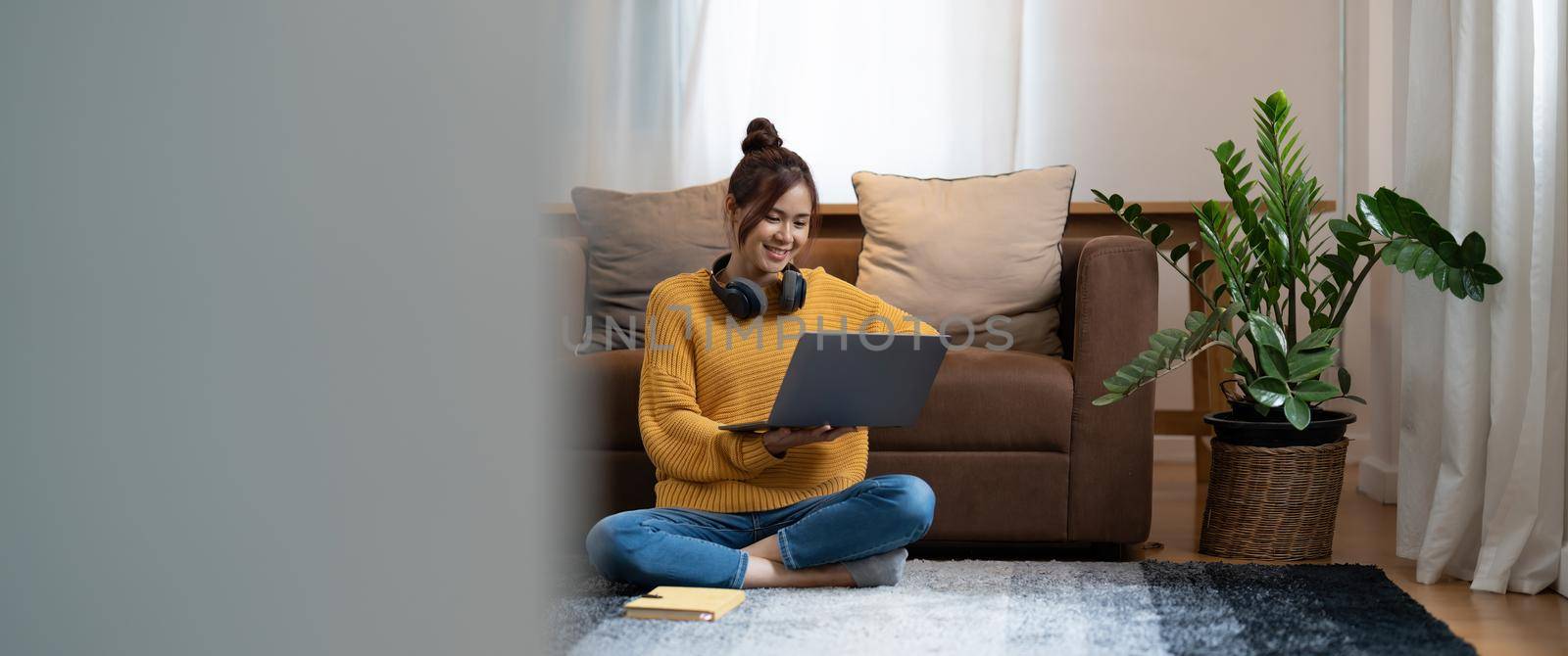 hand typing keyboard laptop online chatting search form internet while working sitting on floor.concept for work from home.technology device contact communication business people by nateemee