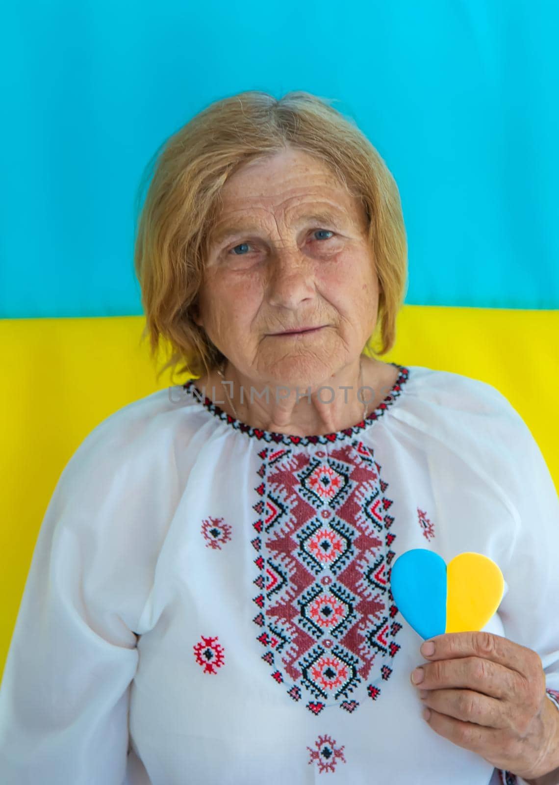 Grandmother is a Ukrainian patriot in an embroidered shirt. selective focus. People.