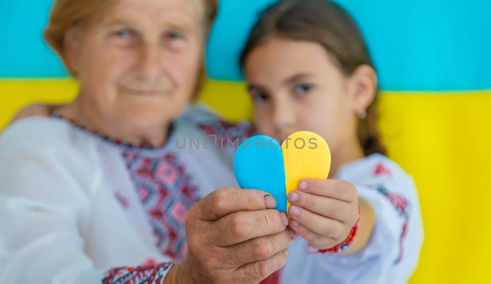 Ukrainian grandmother and granddaughter in vyshyvanka. selective focus. Kid.