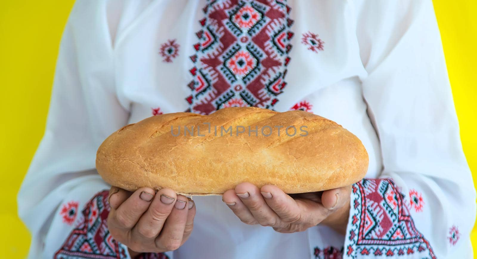 Grandmother is a Ukrainian patriot in an embroidered shirt. selective focus. by yanadjana