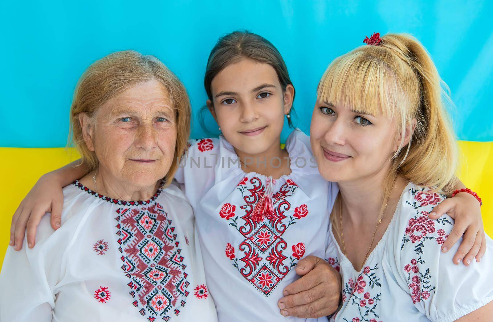 Grandmother and granddaughters in Ukrainian clothes. Selective focus. by yanadjana