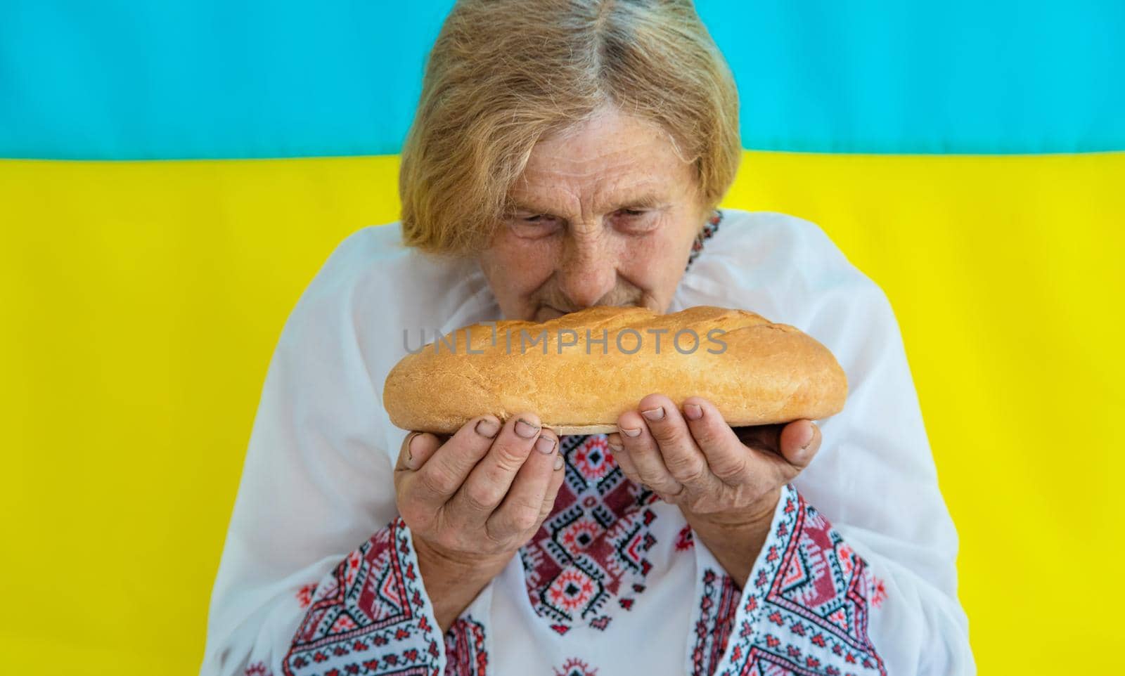 Grandmother is a Ukrainian patriot in an embroidered shirt. selective focus. by yanadjana