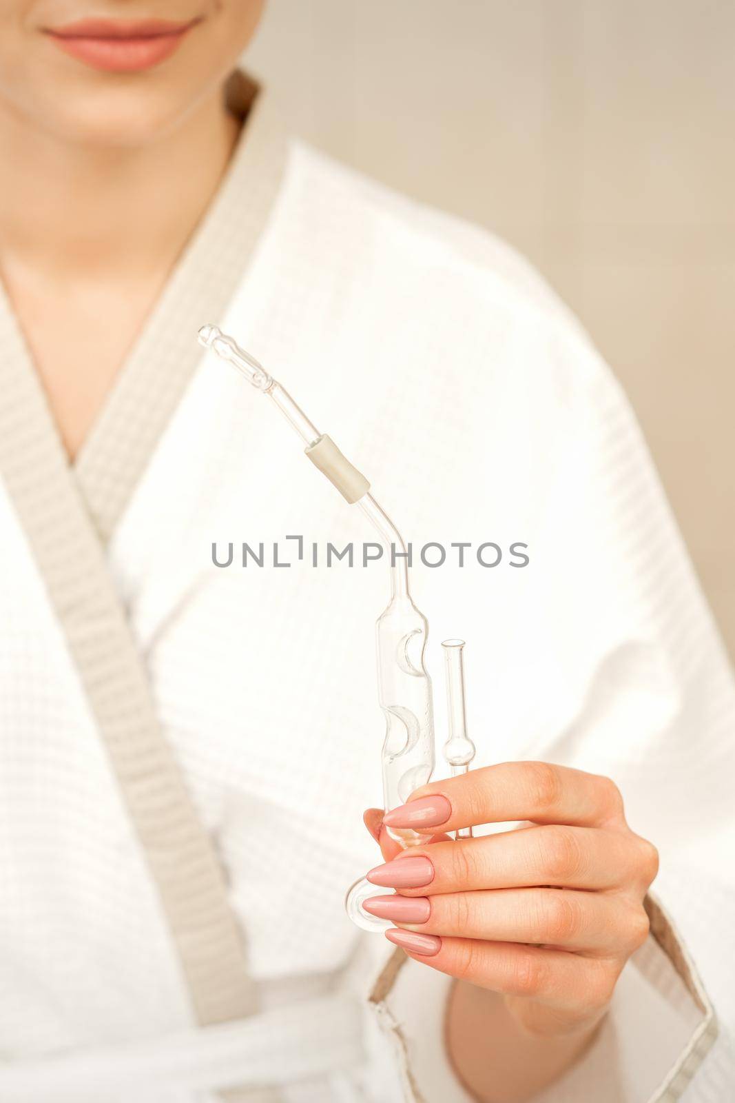 Nasal essential oil inhaler maholda in hands of young woman in spa center