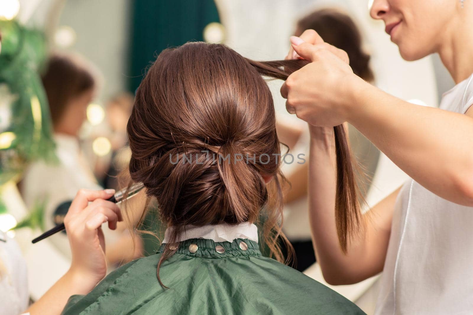 Makeup artist and hairdresser preparing bride by okskukuruza