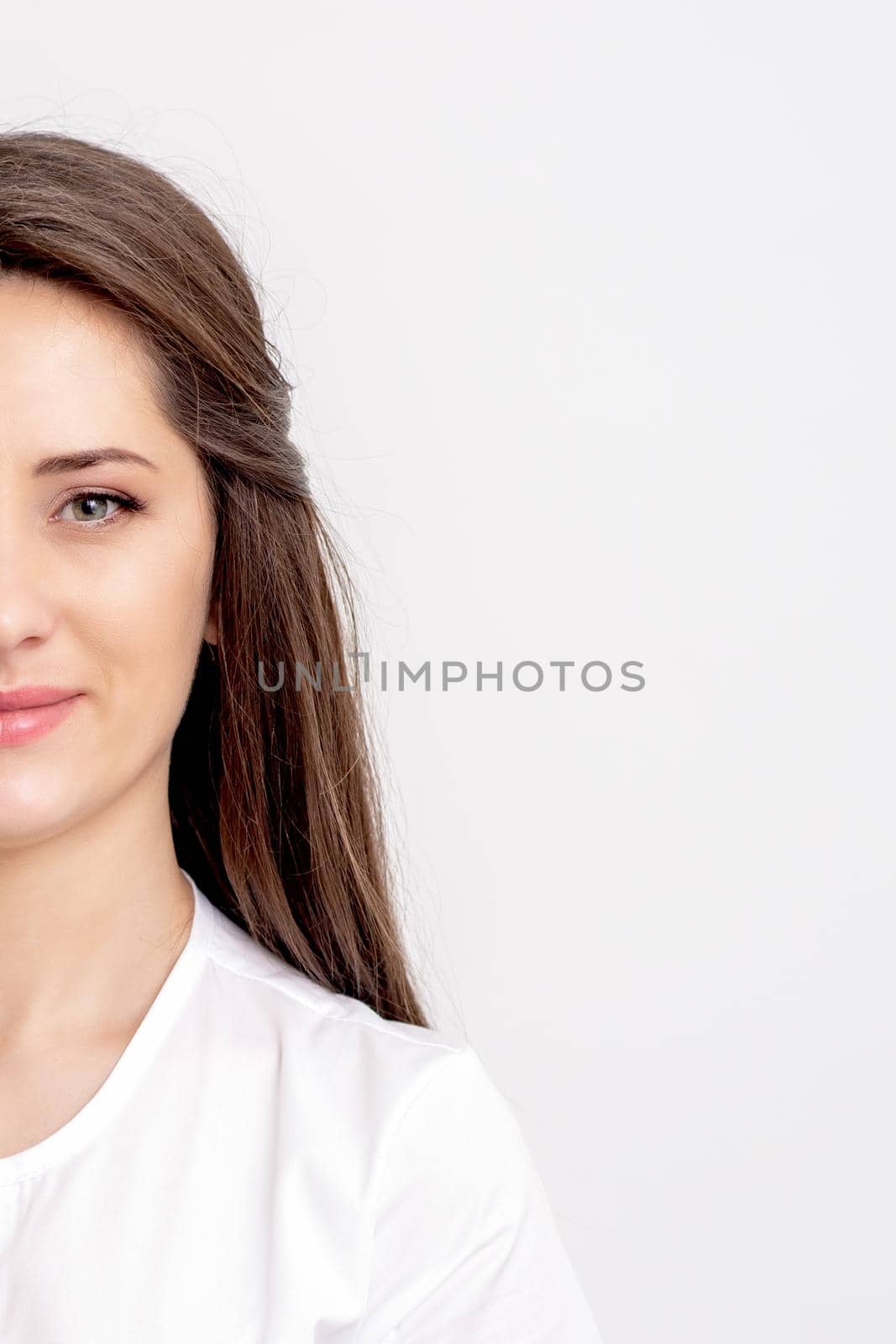 Half portrait of young female thepatist looking at camera on white background