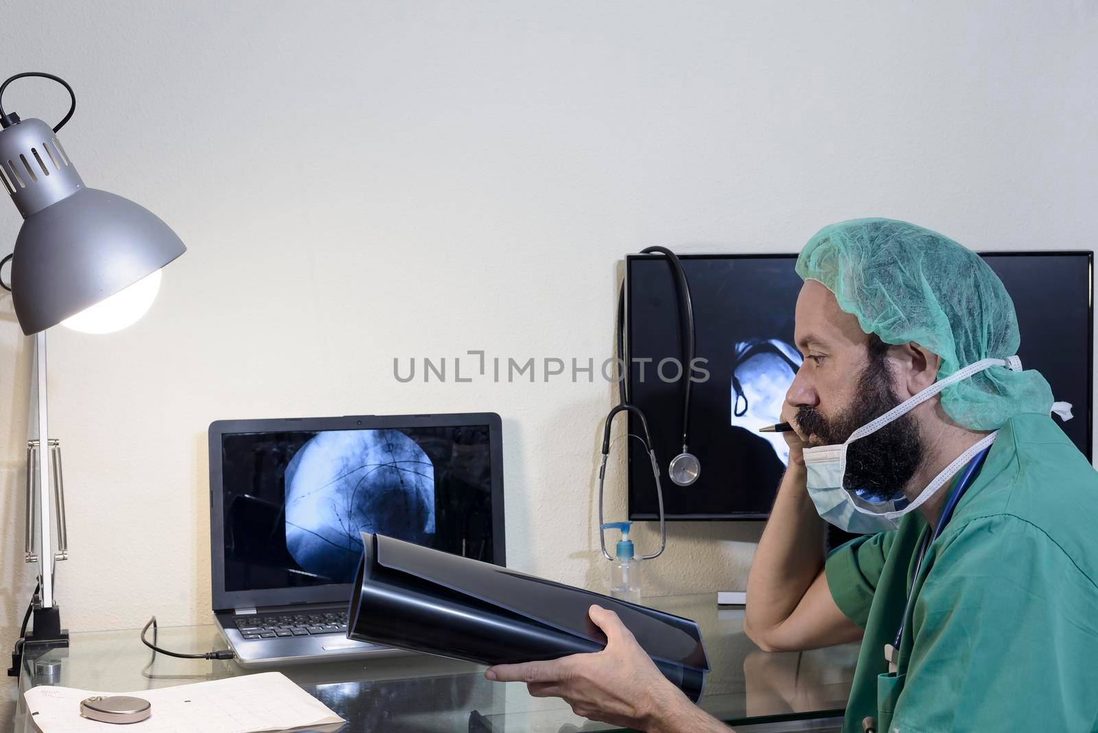 In the medical laboratory, the patient undergoes an MRI or CT scan under the supervision of a radiologist, in the control room, the doctor observes the procedure and monitors the scan results