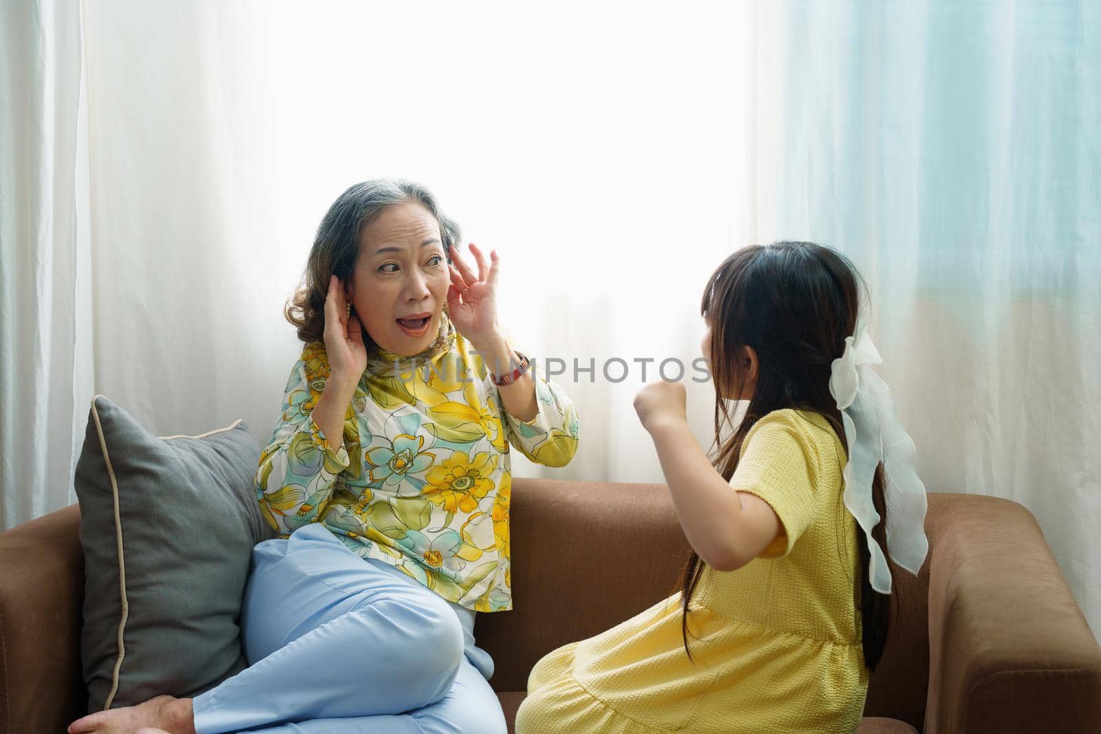 Asian portrait, granddaughter expressing displeasure by yelling at grandmother covering her ears, aggression, violence, upbringing by Manastrong