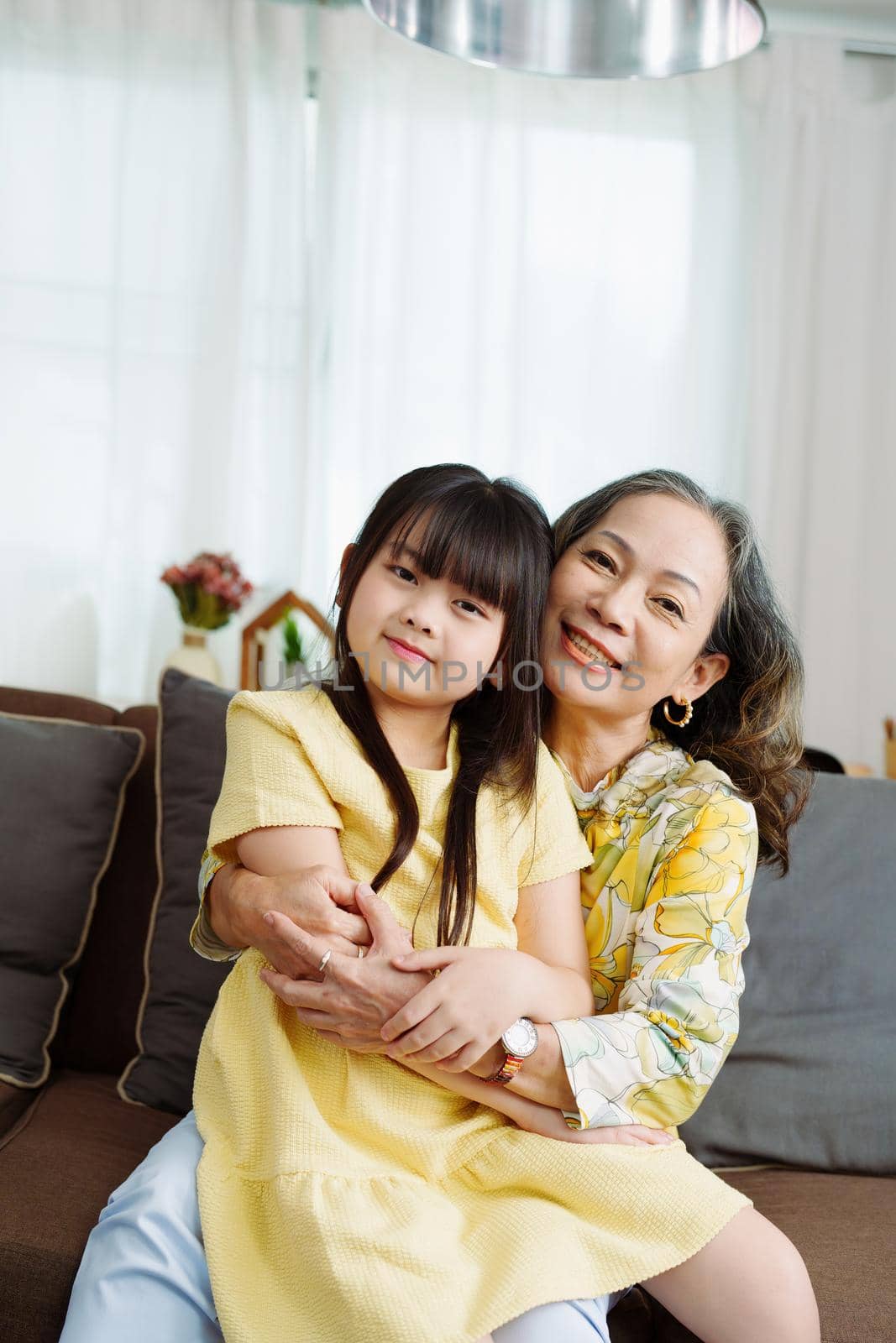 Asian portrait, grandma and granddaughter doing leisure activities and hugging to show their love and care for each other.
