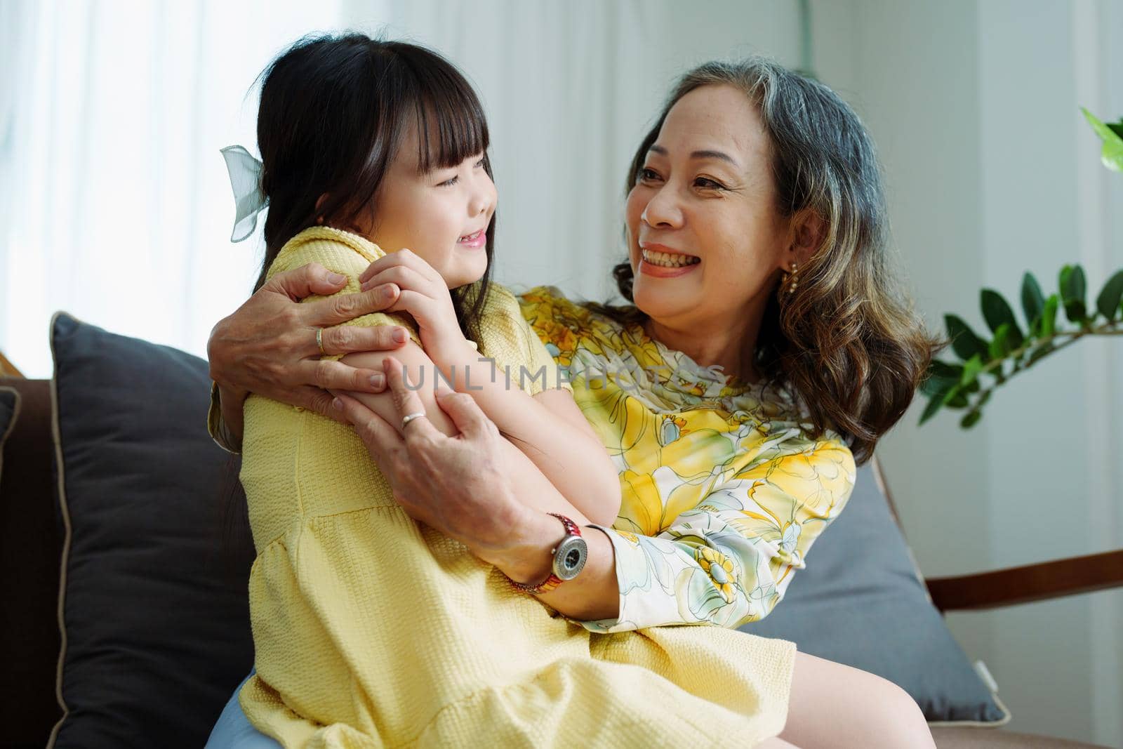 Asian portrait, grandma and granddaughter doing leisure activities and hugging to show their love and care for each other.