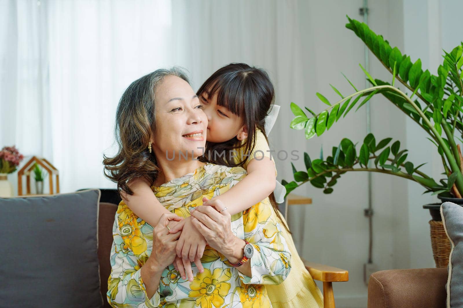 Asian portrait, grandma and granddaughter doing leisure activities and hugging to show their love and care for each other.