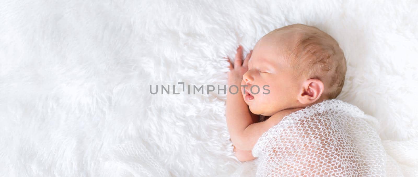 Newborn baby sleeping on a white background. Selective focus. by yanadjana