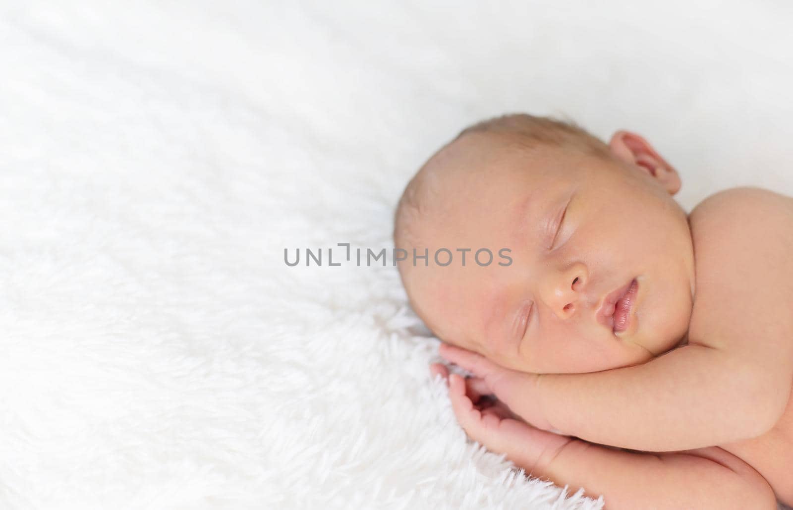 Newborn baby sleeping on a white background. Selective focus. by yanadjana