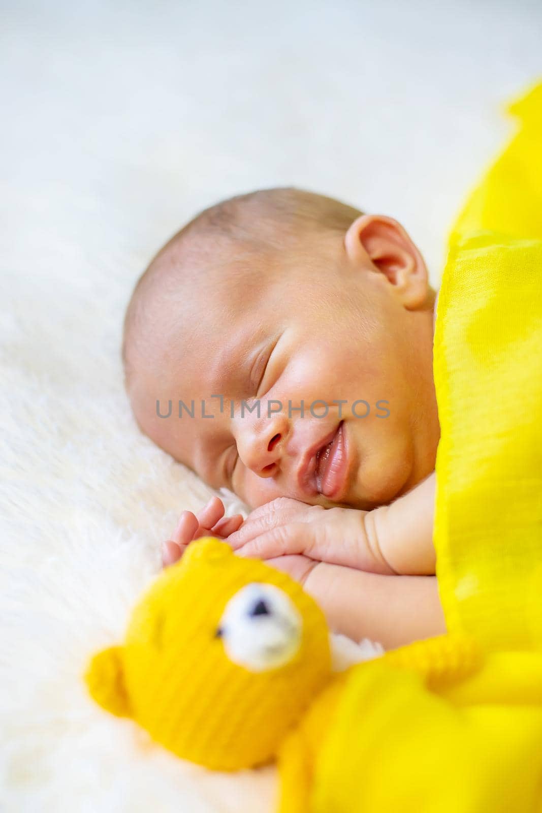 Newborn baby sleeping on a white background. Selective focus. by yanadjana