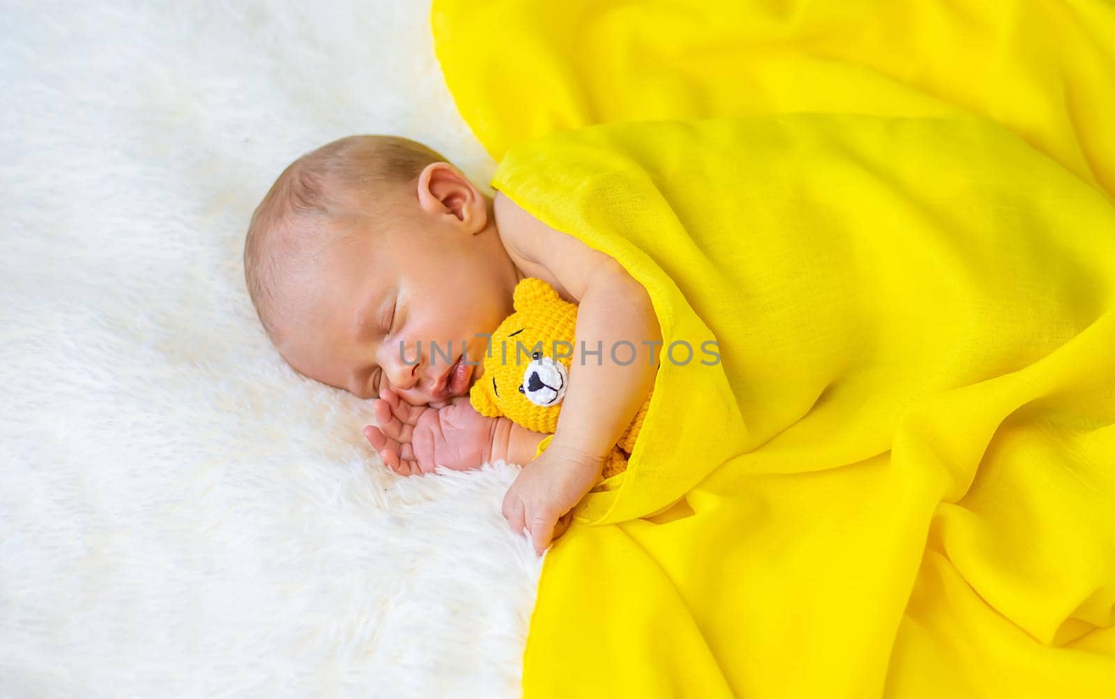 Newborn baby sleeping on a white background. Selective focus. by yanadjana