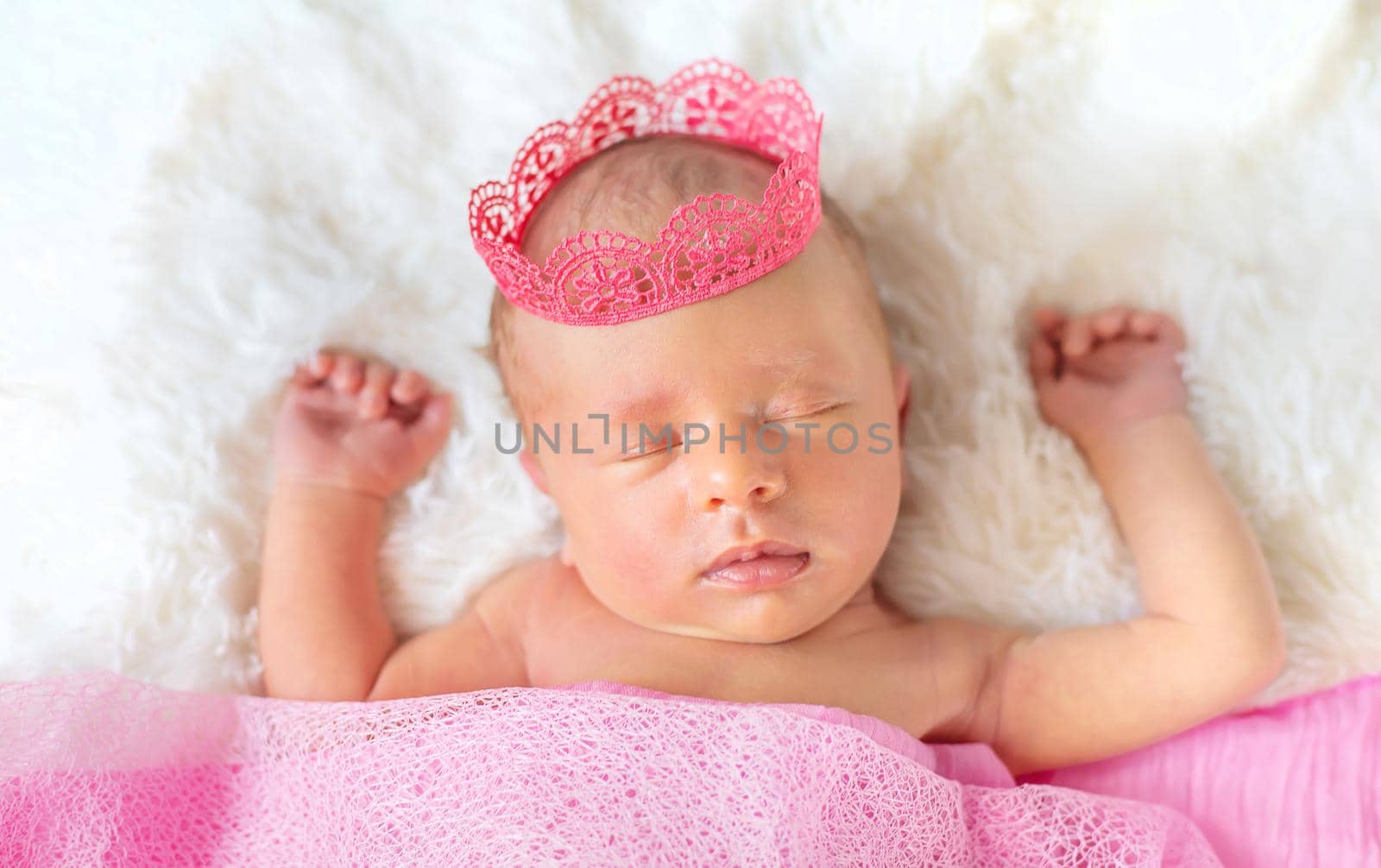 Newborn baby in a girl crown. Selective focus. by yanadjana