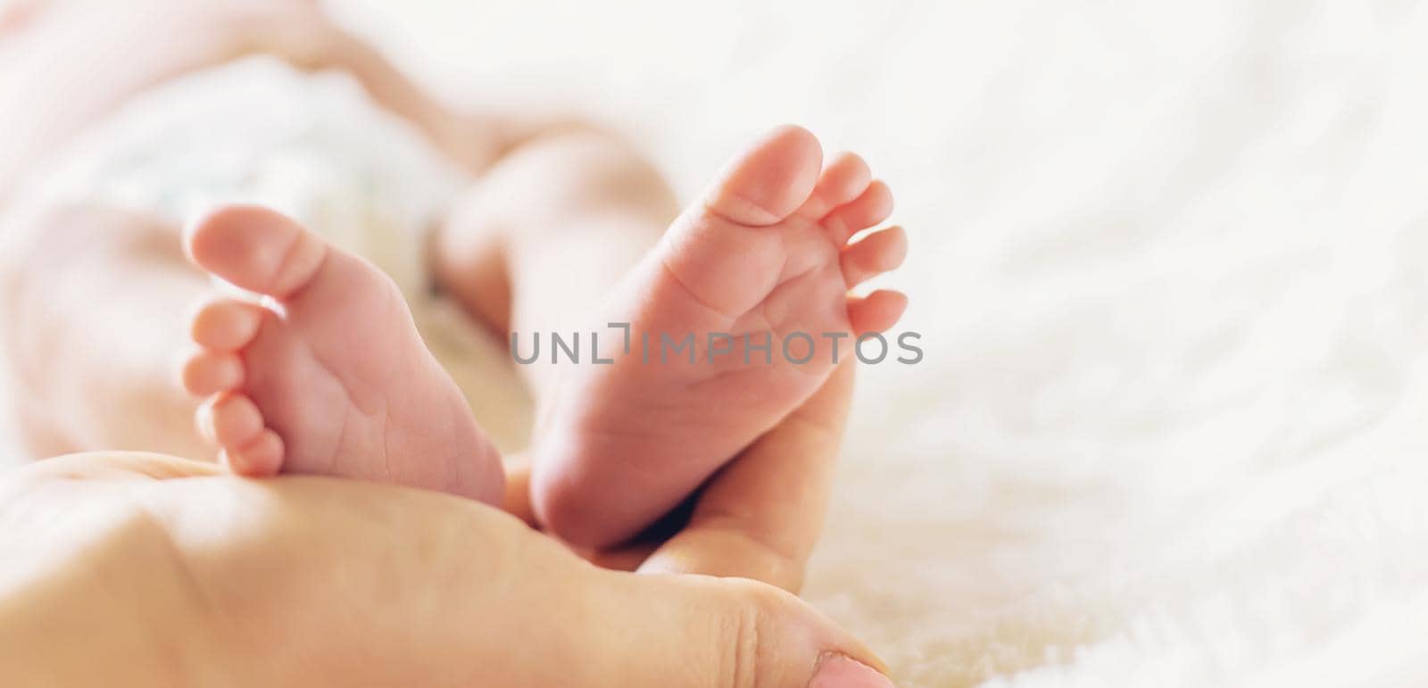 newborn baby mom holds legs. selective focus. by yanadjana