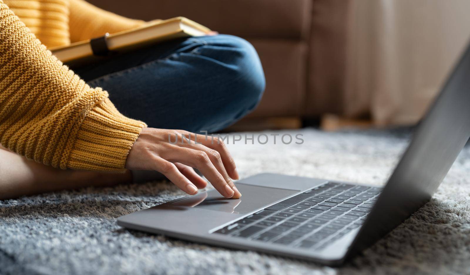 Close up of female hands while typing on laptop for online learning at home