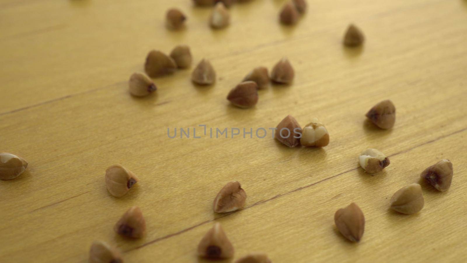 Buckwheat groats on a wooden surface. Macro shot of buckwheat. 4k