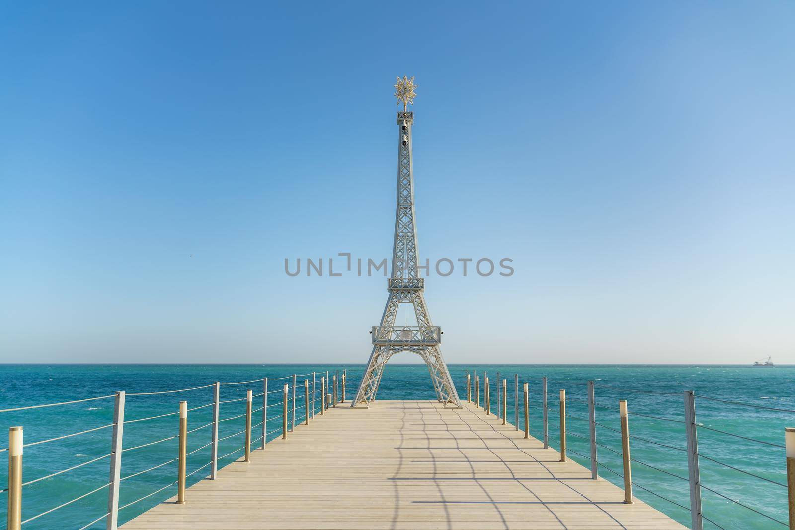 Large model of the Eiffel Tower on the beach. by Matiunina